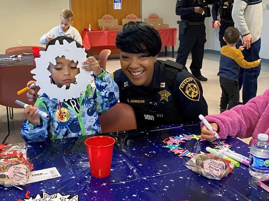 Sherrif Deputy at Table with Kids Coloring Paper Cutouts