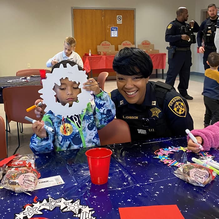 Deupty Sheriff at Table with Kids Coloring Paper Cutouts